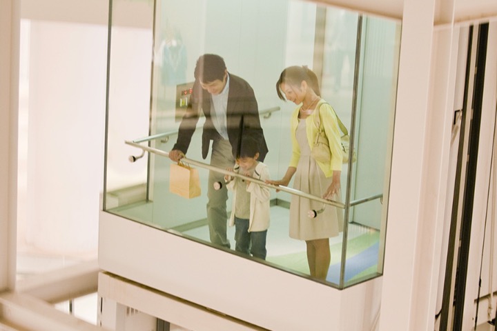 People looking down from elevator