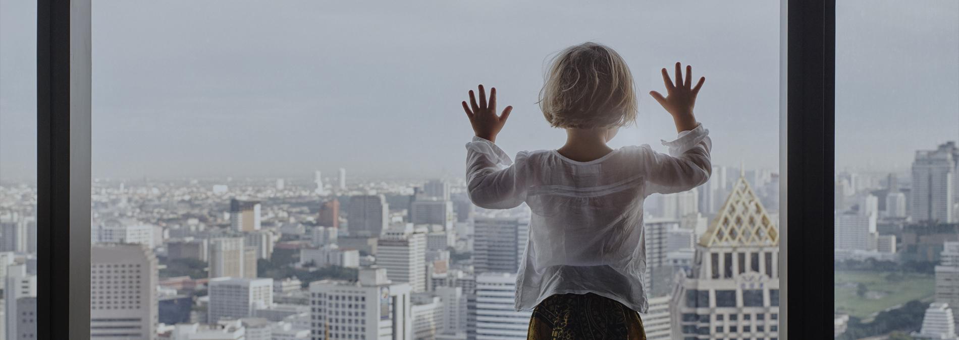 Girl looking through glass windows