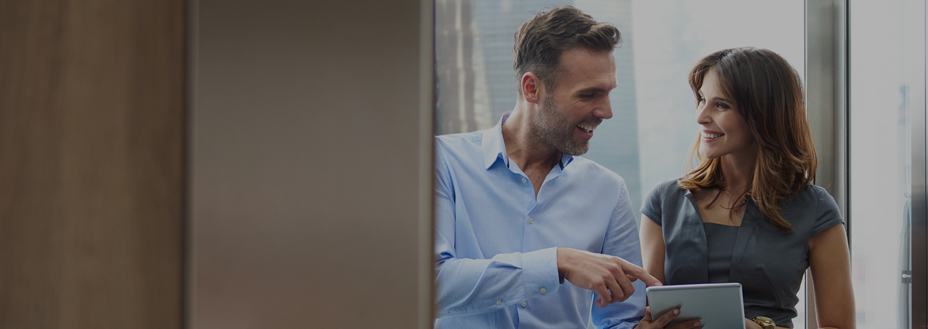 man-and-women-on-ipad-in-elevator