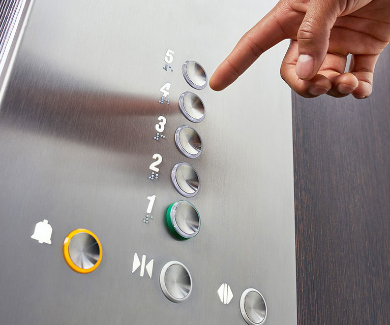 man hand pressing elevator button 