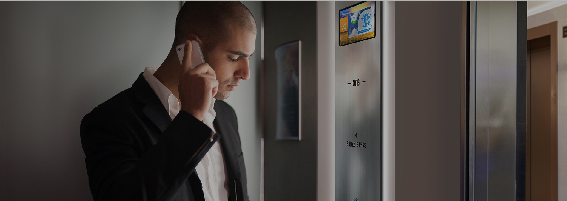 man-on-phone-in-lift-1900x675