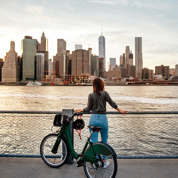 NYC-skyline-woman-with-bicycle-675x675