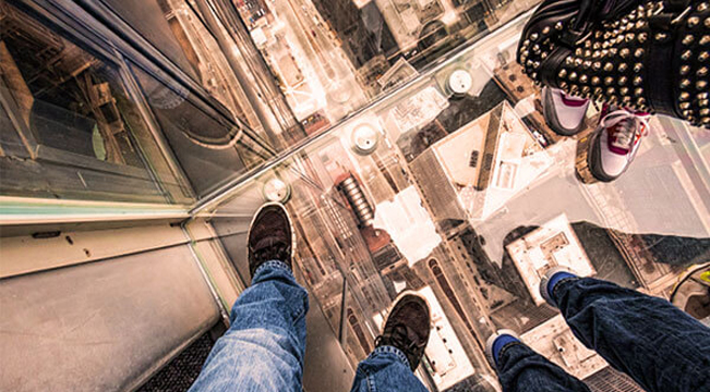 Image of peoples feet in an glass floored elevator