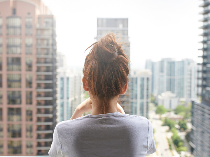 young-woman-looking-over-balcony-950x950