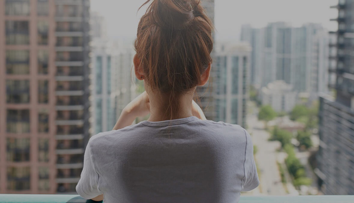 girl looking out from balcony