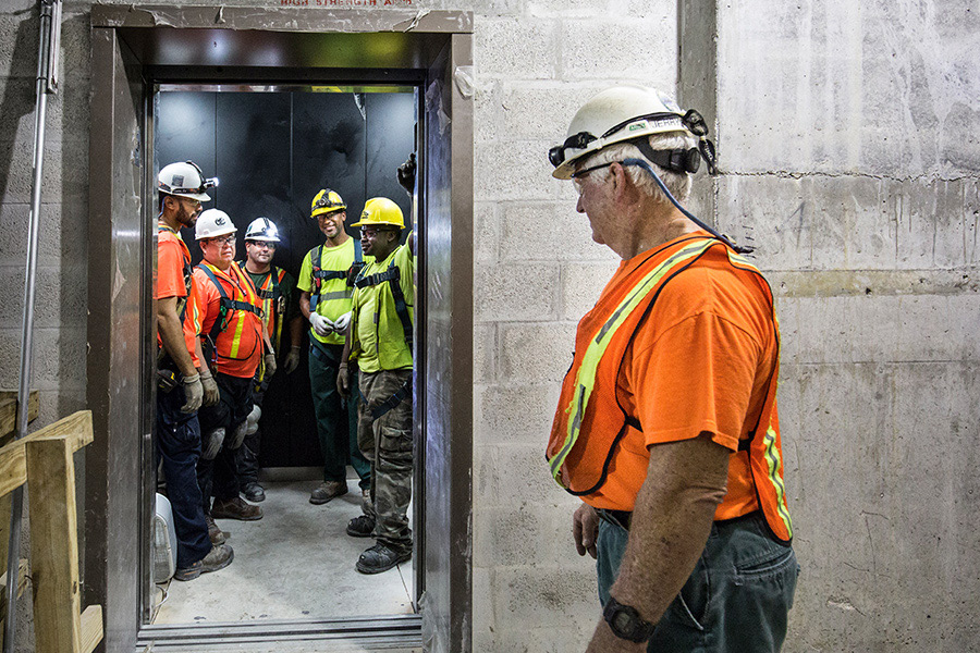 Group of service mechanics working on an elevator