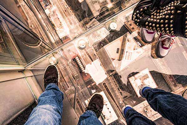 people standing on glass lift