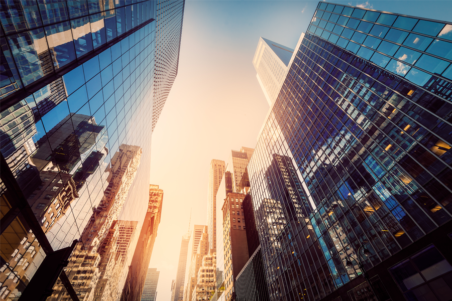 Looking up at city of buildings at sunrise