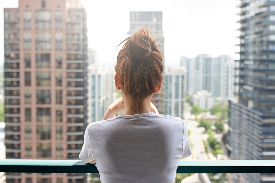 girl looking out from balcony