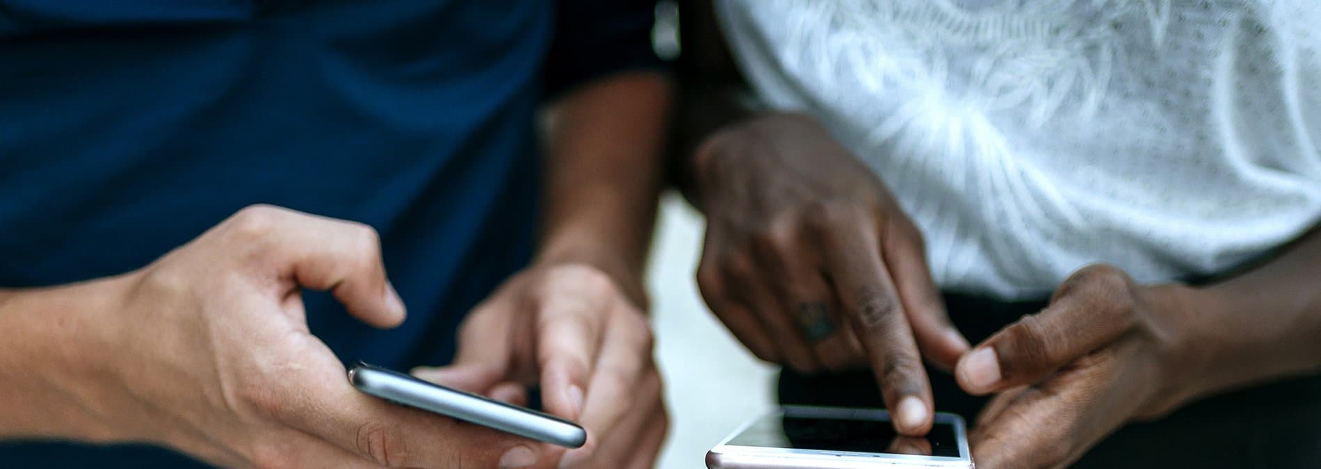 Close up of people using their phones