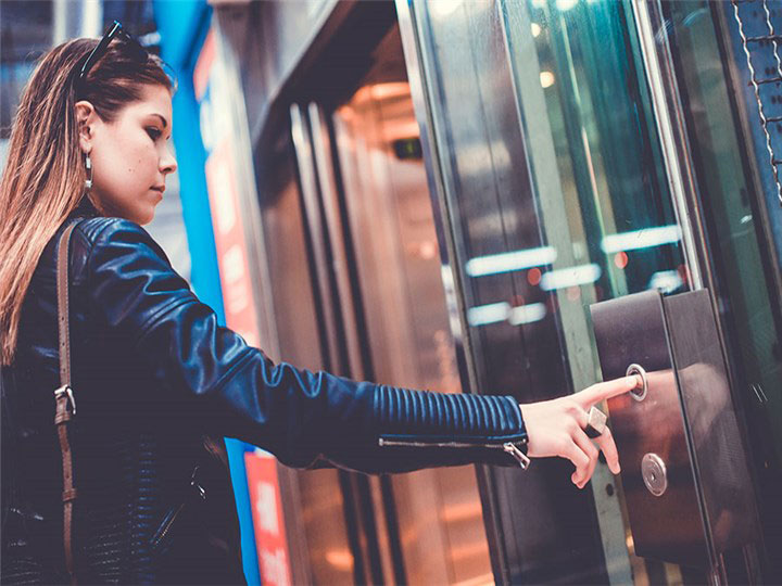 lady-pushing-elevator-button