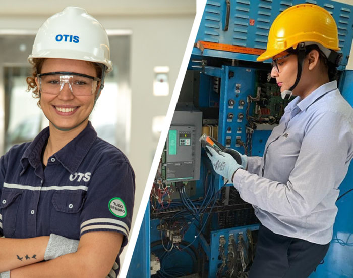 Two women Otis elevator mechanics smiling and working