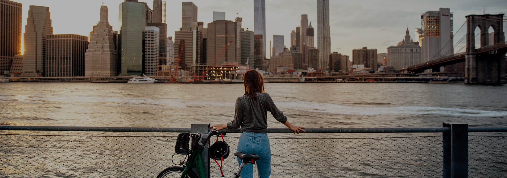 NYC-skyline-woman-with-bicycle