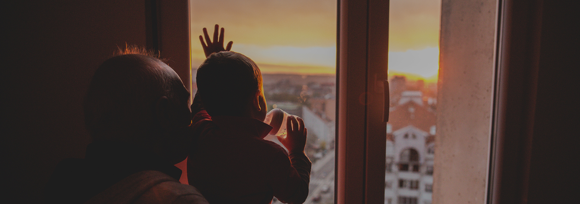 grandfather-grandson-looking-out-window