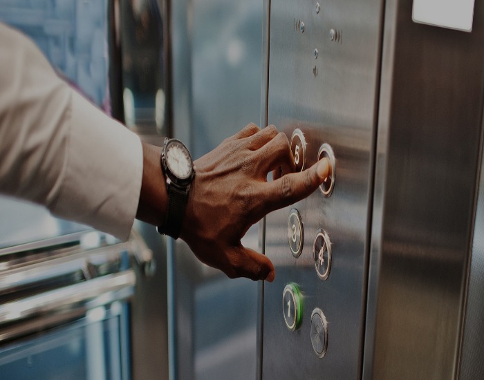 A man pressing button in lift