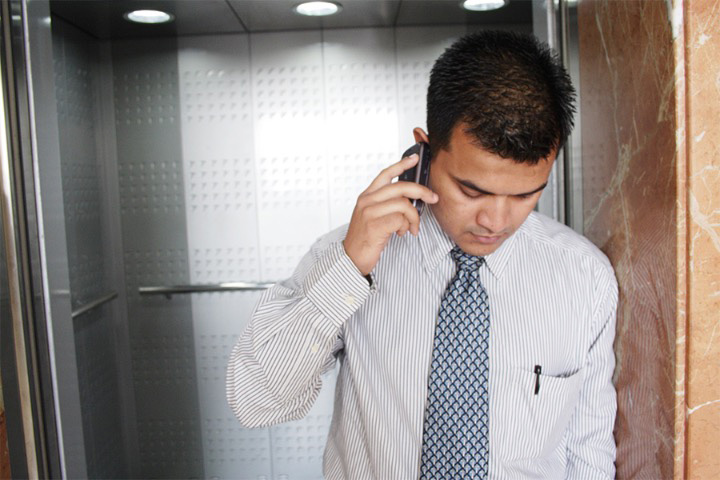 man-on-phone-in-lift