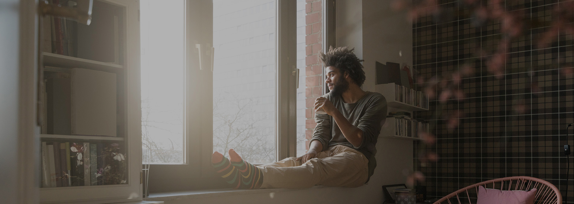 man-sitting-on-window-sill