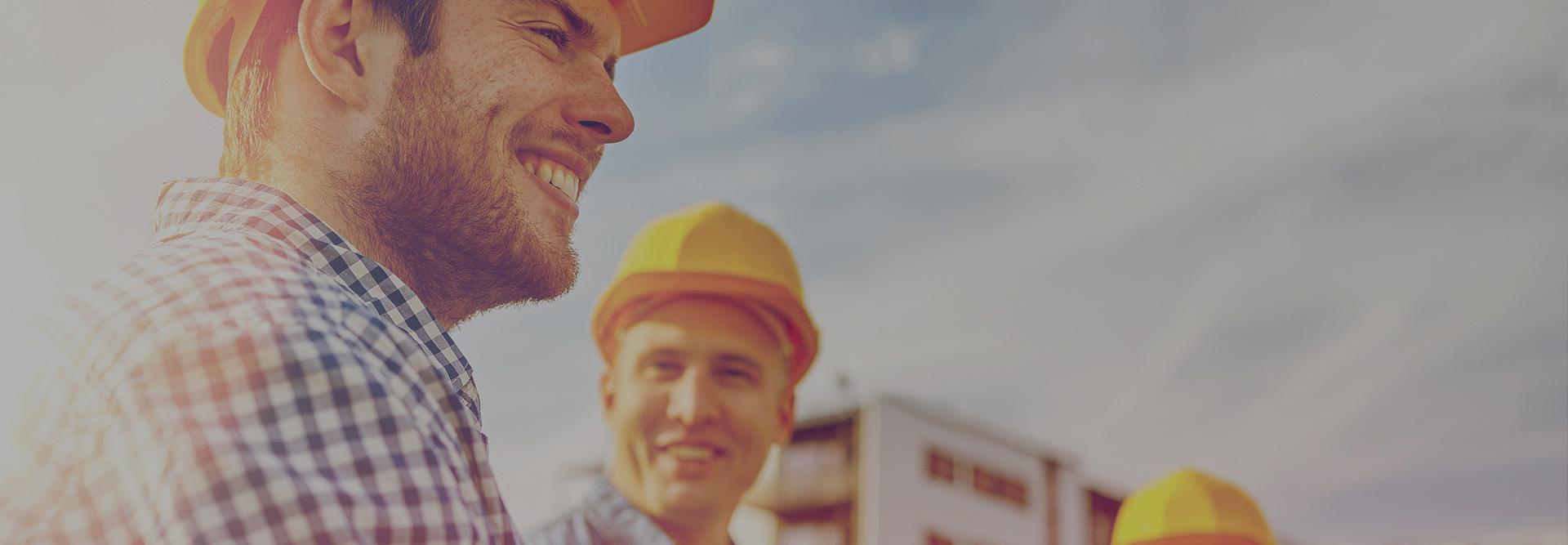 Builders smiling in a corner of the image