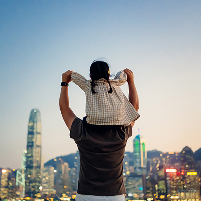 girl sitting on shoulders of a man