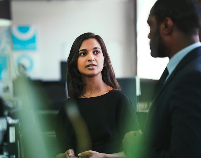 Woman having a conversation with a colleague in the office