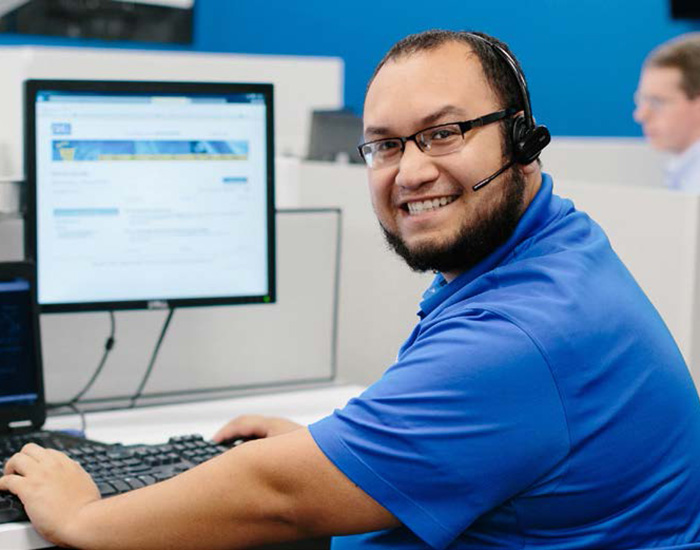 Man smiling while working at a computer