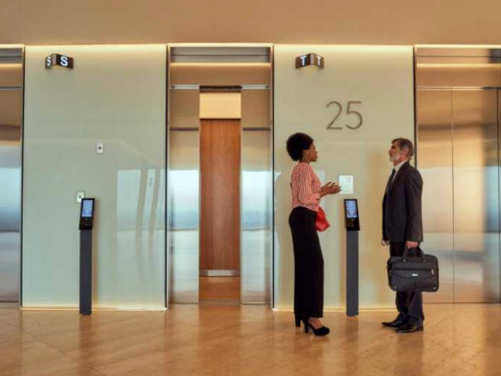 Man and woman in front of elevators