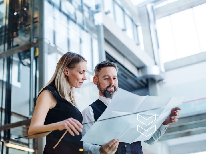 Man and woman standing looking at a diagram