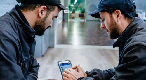 Mechanics looking at a phone 