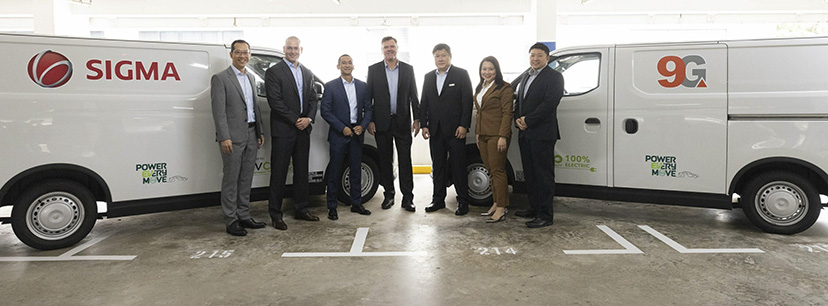 People in front of 2 new Electronic Vehicles