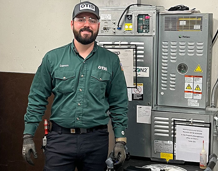 Otis employee in a machine room