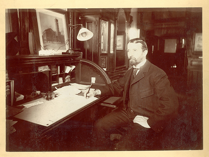 Portrait of Charles Seeberger at desk in 1899