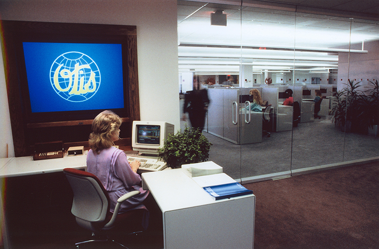 Woman sitting at desk at OTISLINE office