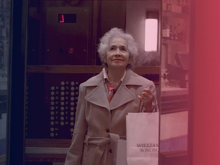 Older woman exiting an elevator at a department store