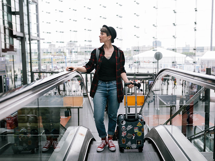 Female at the top of an escalator at an airport