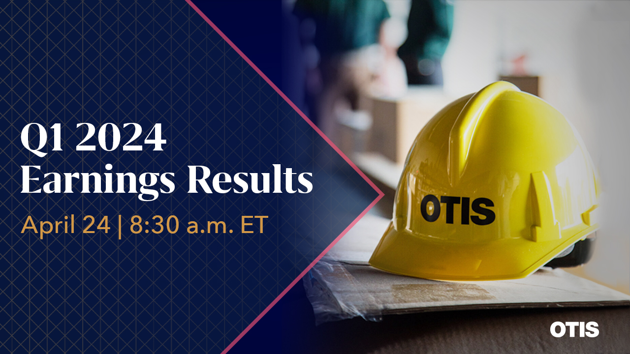 Navy background pointing to Otis hardhat on a desk 