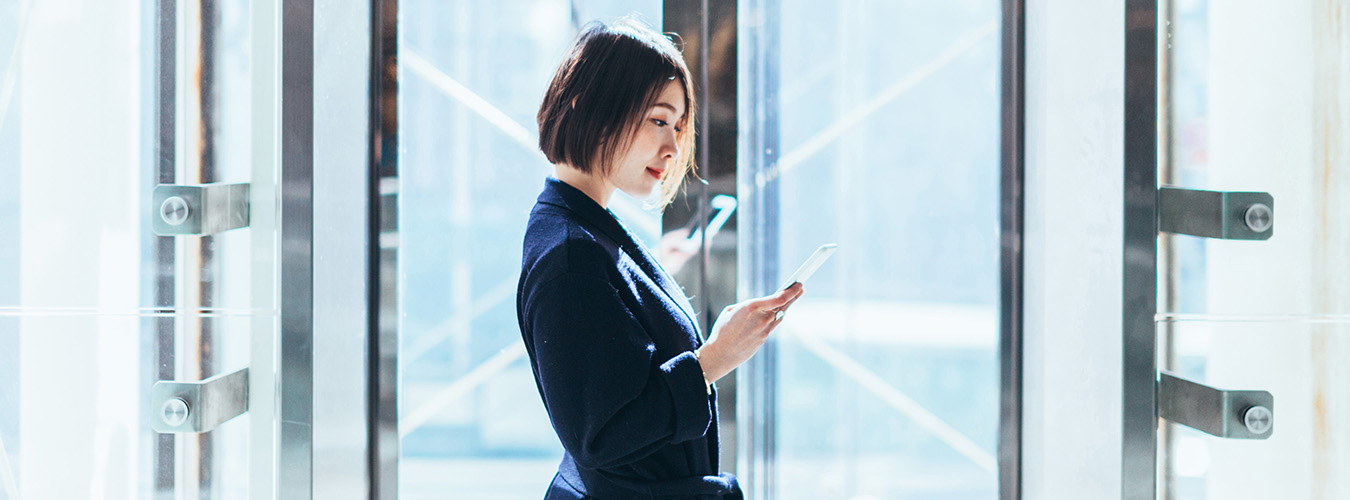 Person looking at smart phone while waiting for a Gen3 MOD elevator