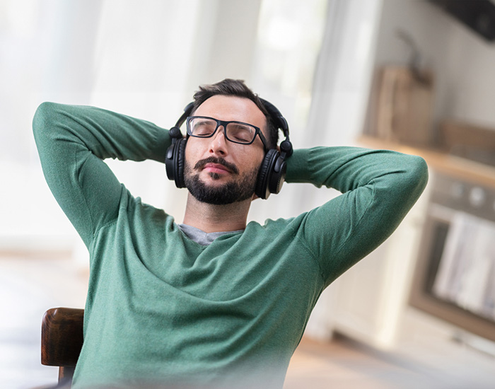 Man relaxing with headphones on