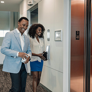 Man and woman entering an elevator