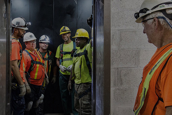 Otis technicians in a SkyBuild elevator