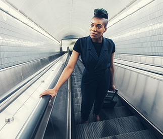Woman riding up an escalator