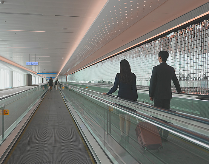 People standing on a moving walk at Incheon International Airport