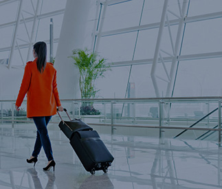Woman traveling through an airport with her luggage