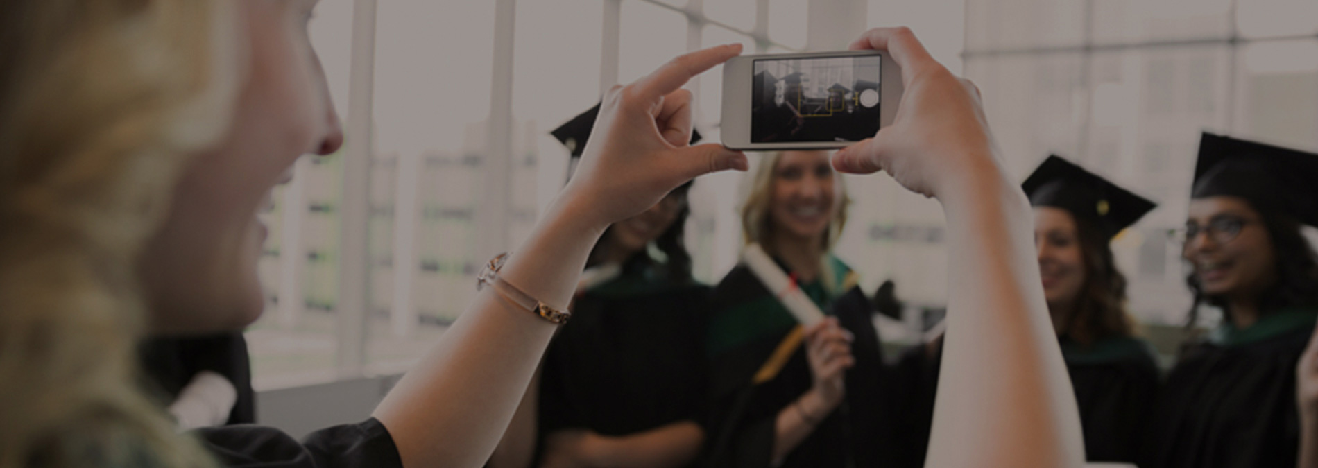 girl taking picture of her friends on phone 