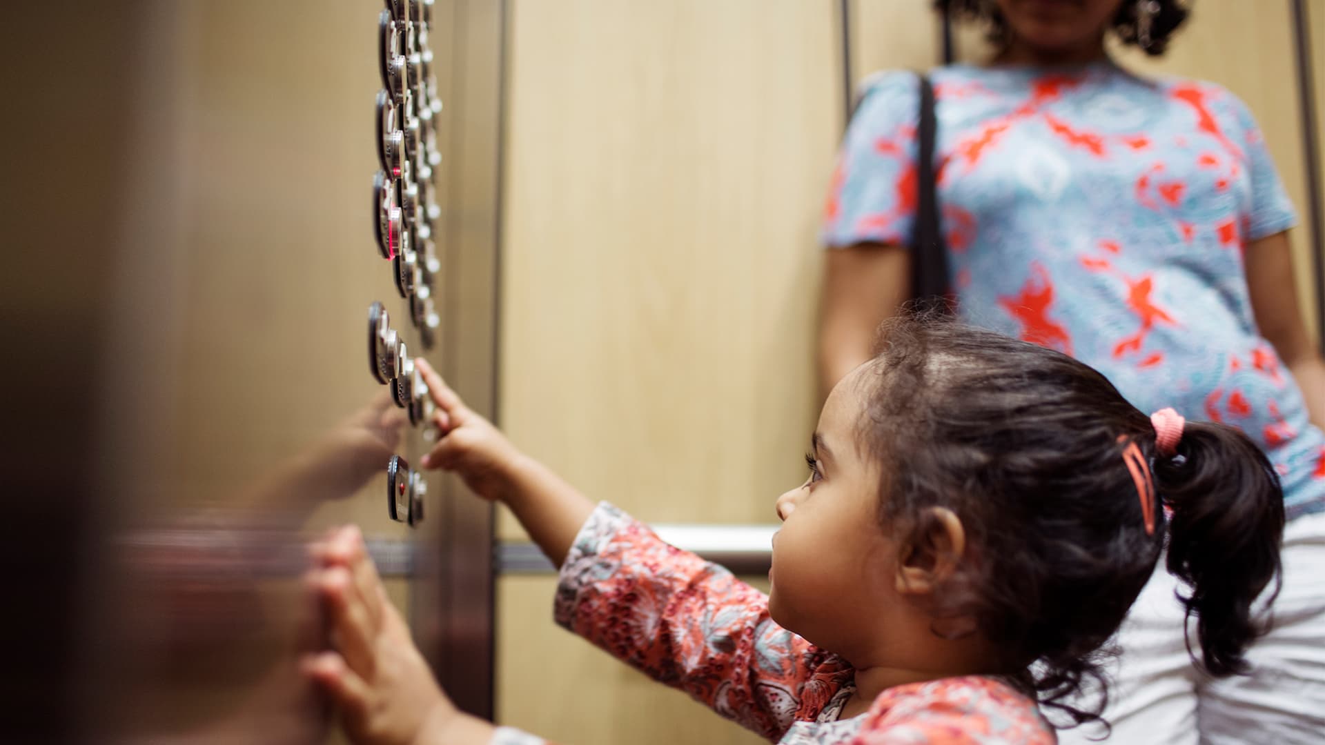 young-girl-pressing-button-on-elevator