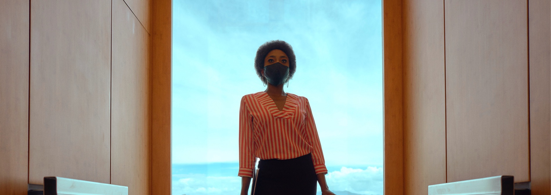 Woman in elevator with mask 