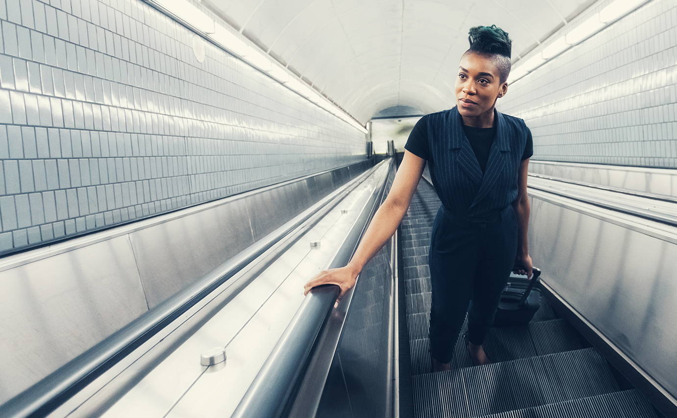 woman moving up on escalator