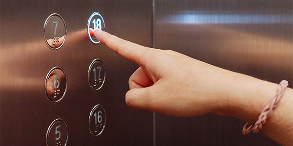 lady hand pressing elevator button 