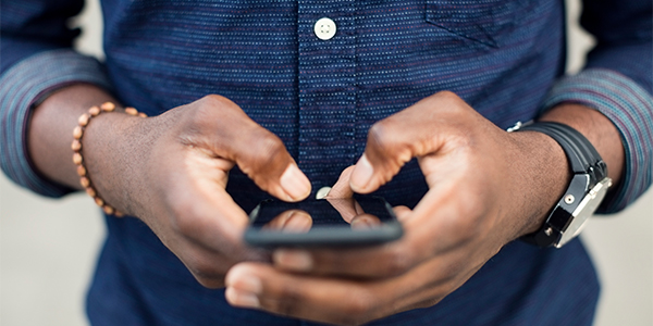 male hand holding a smart phone