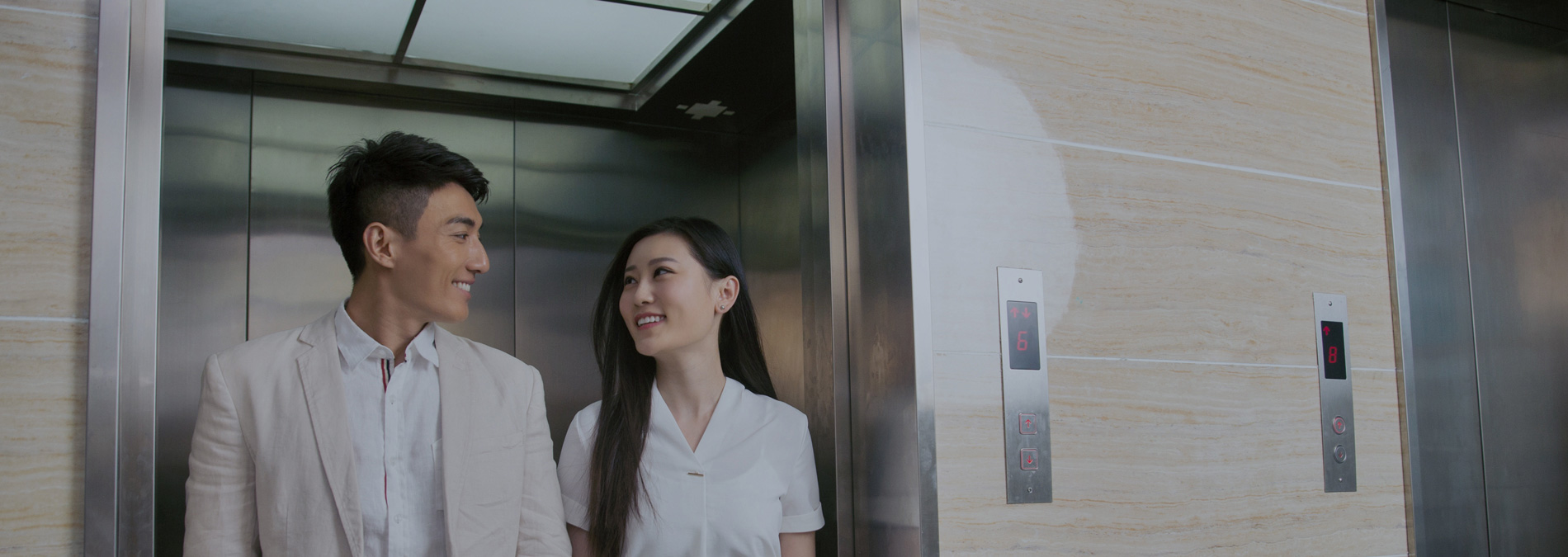 smiling people while walking out of the elevator